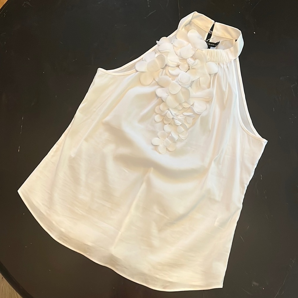 WHBM sleeveless white top. Floral detail on front. Size medium. NWOT